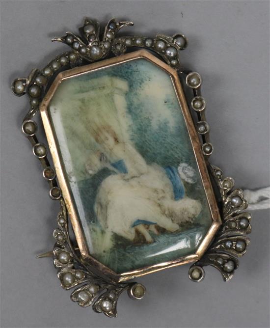 A 19th century continental white and yellow metal pendant brooch, with seed pearl set border and inset portrait of a lady, 5cm.
